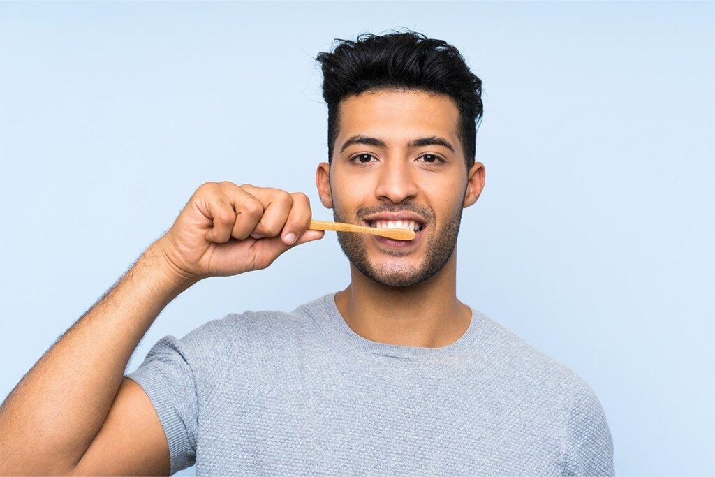 Dental Care Mistakes You Didn’t Know You Were Making 1 A person brushing their teeth using a soft bristled toothbrush