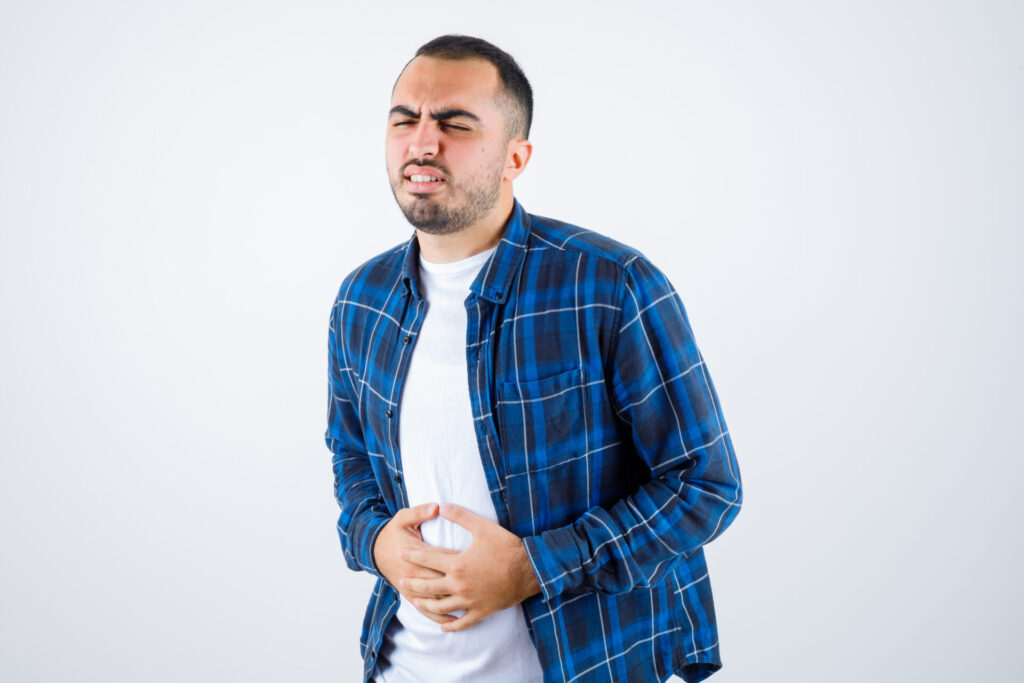 Vitamin B12 and D Deficiency: Symptoms, Causes, and Recovery Tips 1 Person suffering from digestive issues due to Vitamin B12 deficiency.
