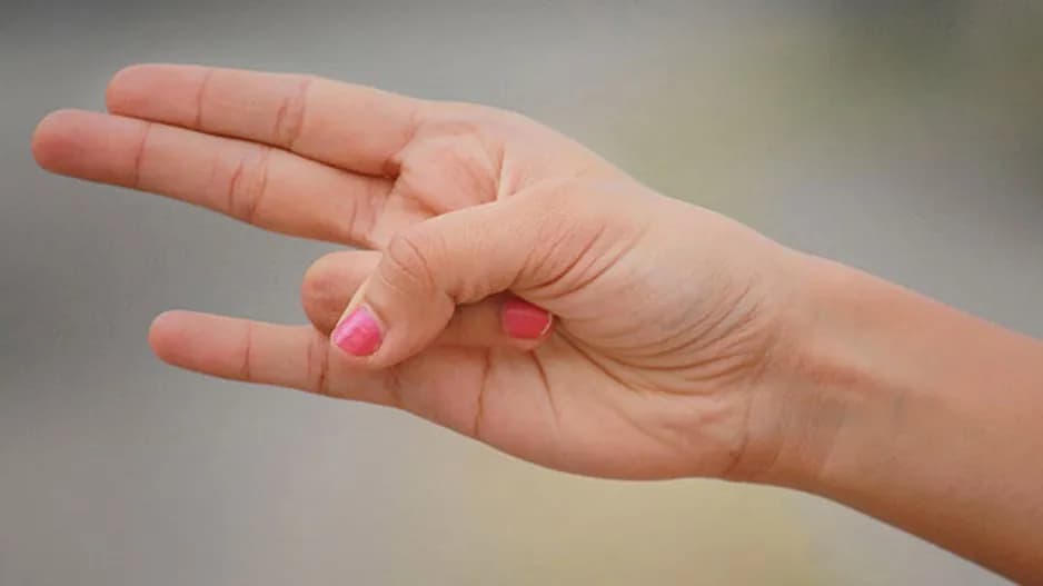 Person practicing Agni Mudra hand gesture to activate the fire element