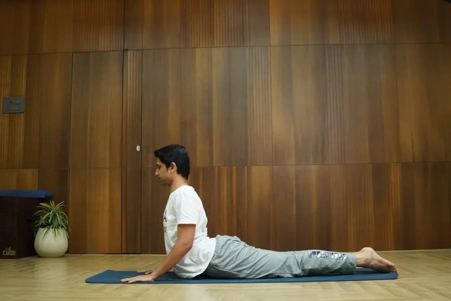 Person practicing Bhujangasana cobra pose backbend