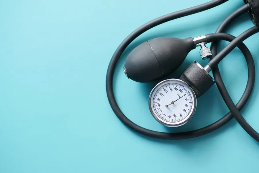 Blood pressure monitor on a table, representing the topic of mudra for high BP