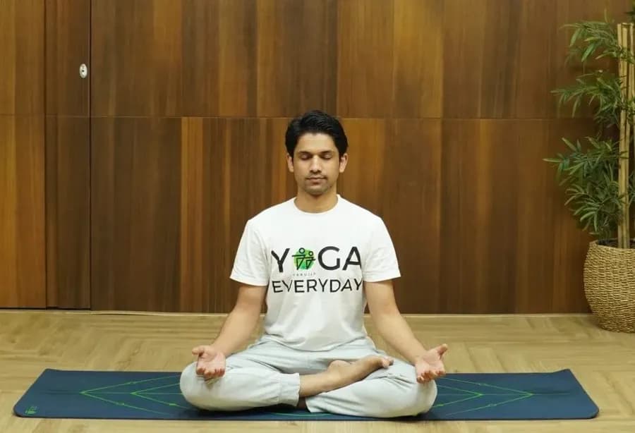 Person seated in Padmasana lotus pose meditating