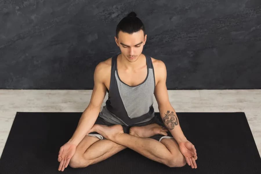 Person practicing yoga meditation in lotus pose