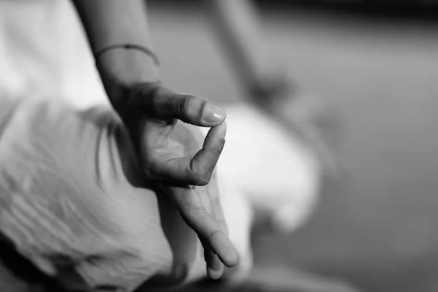 Hands forming Gyan Mudra to prepare for sleep
