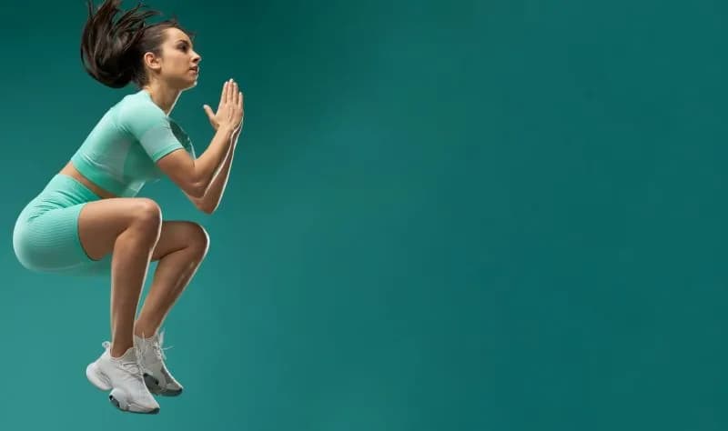 athletic woman jumps high against teal backdrop 2026 01 09 07 43 25 utc 2