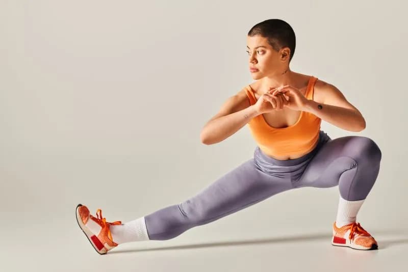 athletic-woman-stretching-in-workout-gear-indoors-2026-01-09-12-36-22-utc.jpg