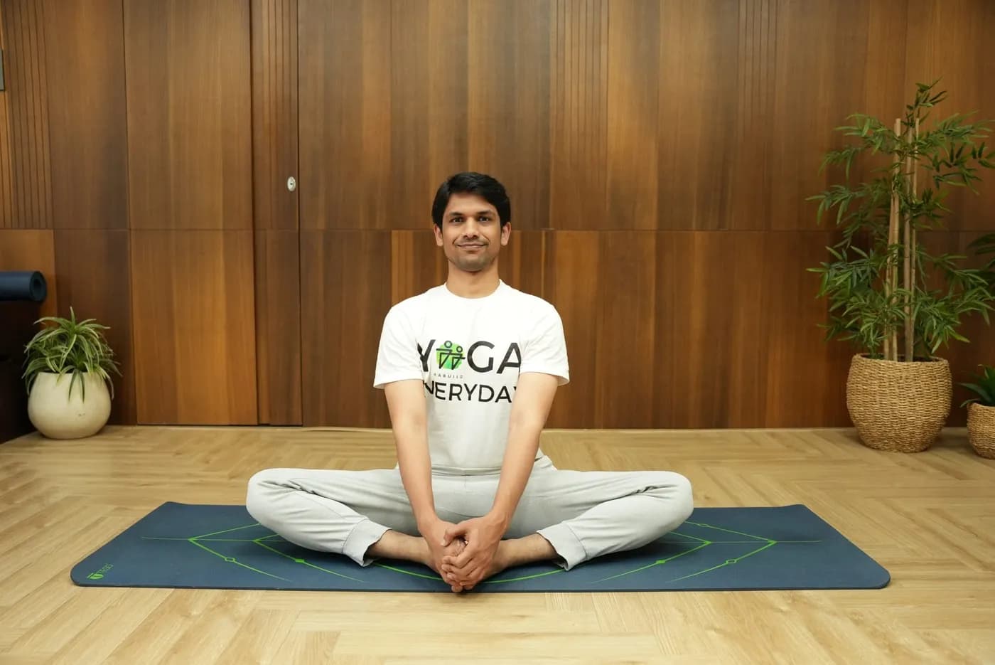 Person seated in Baddha Konasana (Butterfly Pose) with soles of the feet together and knees open