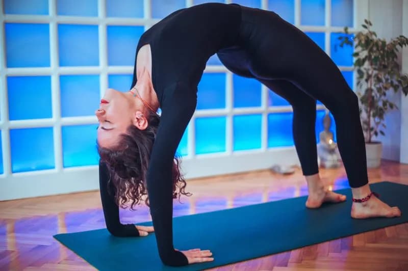 Woman practicing a bridge pose as preparation for Chakrasana