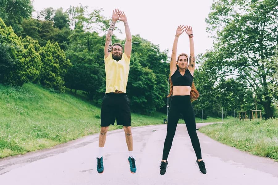 Couple stretching before a full-body cardio workout