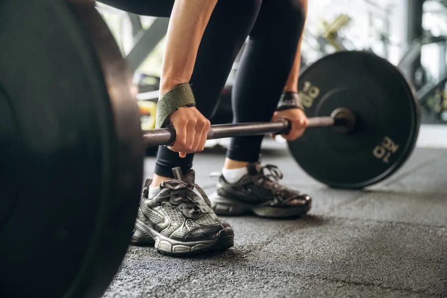 Woman lifting a barbell during a strength training workout