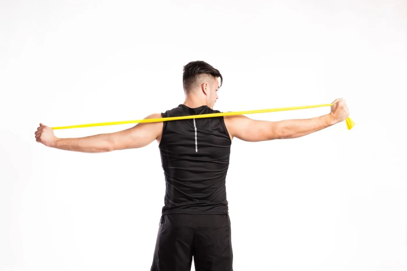 Person training shoulders with dumbbells to build broader, stronger shoulders