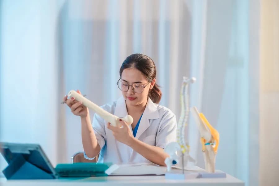Medical professional explaining bone structure and bone density to a patient