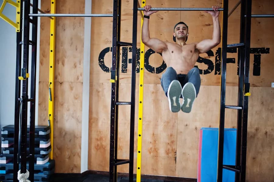 Man performing crossfit-style workout exercises at home