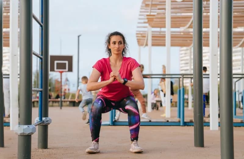 curly spanish young woman in sportswear makes squ 2026 01 06 10 38 03 utc