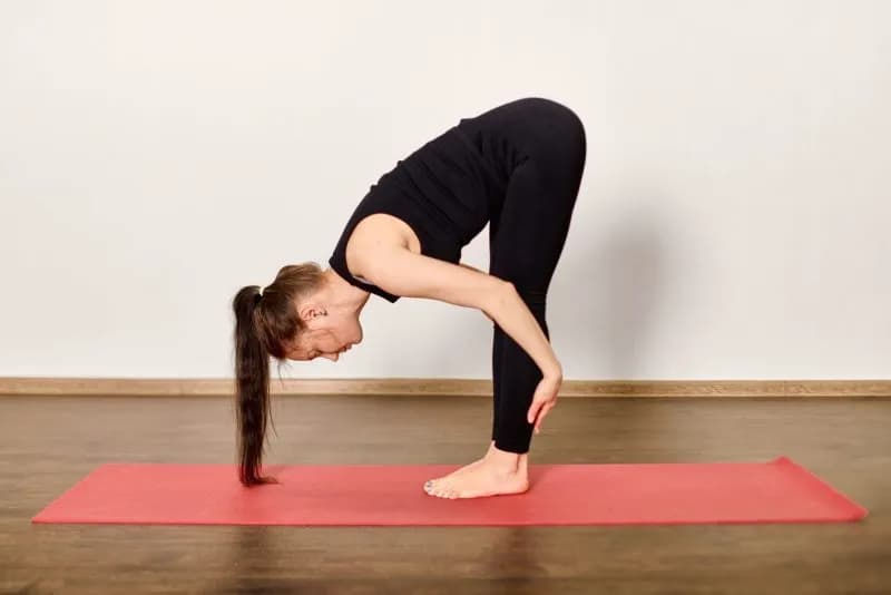 forward fold pose on red yoga mat 2026 03 25 22 43 04 utc