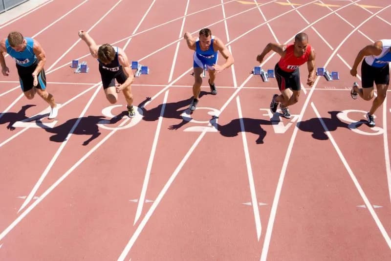 Sprinters in starting position preparing for a sprint interval workout