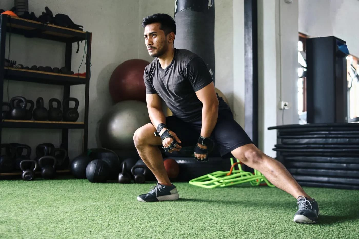 Man stretching before exercising in the gym