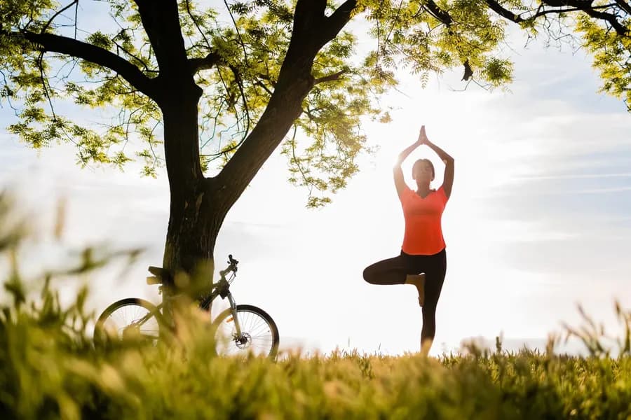 Woman in tree pose practicing yoga for heart health