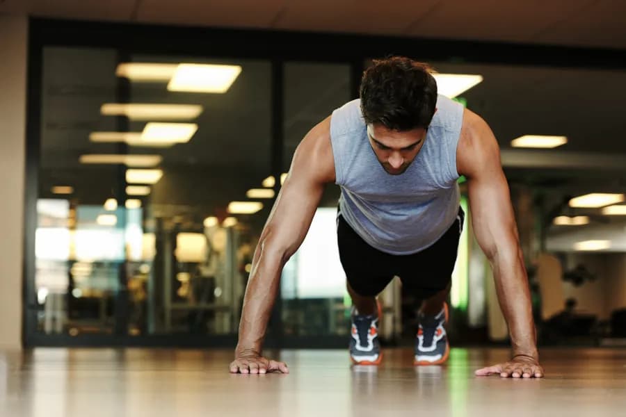 Man pushing himself through a strength training session