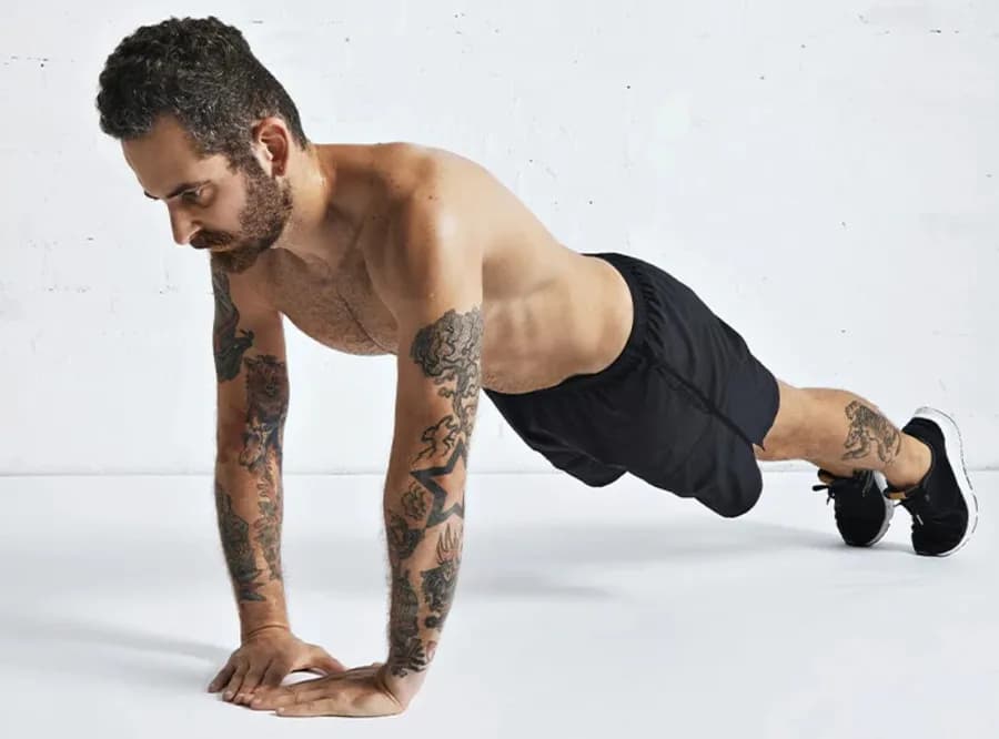 Man performing a diamond push-up with hands forming a diamond shape
