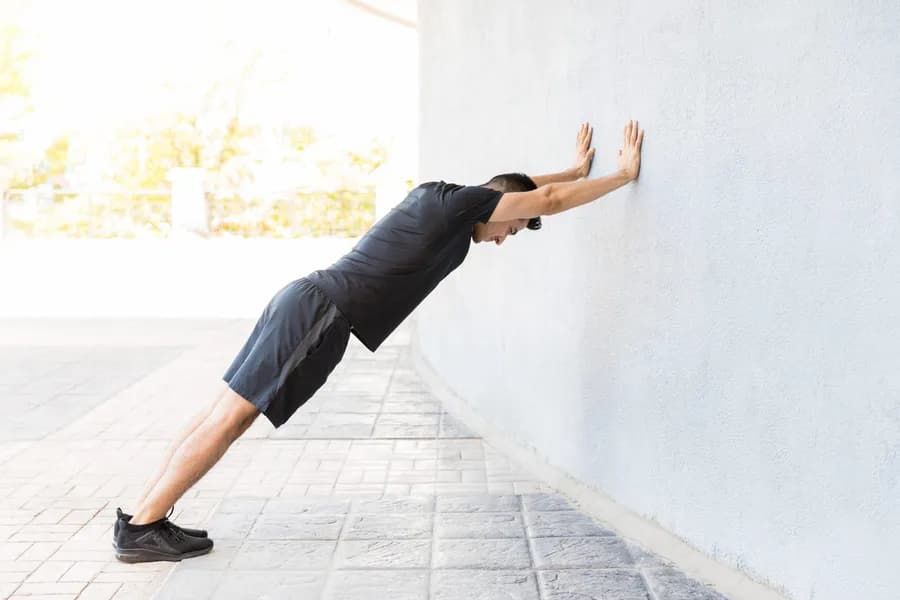 Man performing wall push-ups