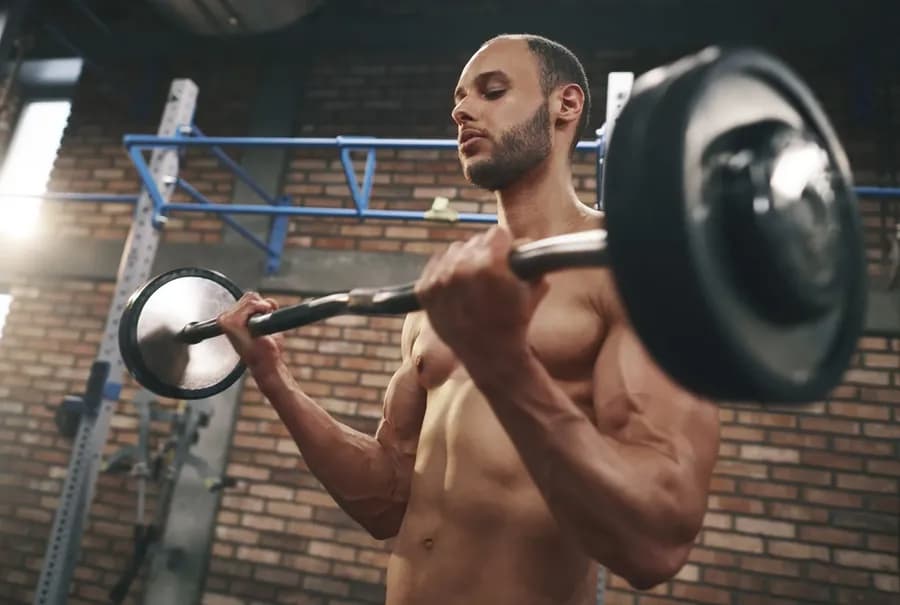 Person training with dumbbells to build muscle mass