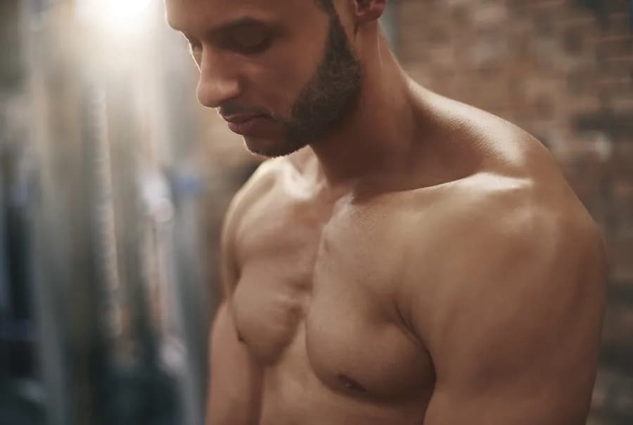 Close-up of a muscular man's chest, representing chest strengthening exercises