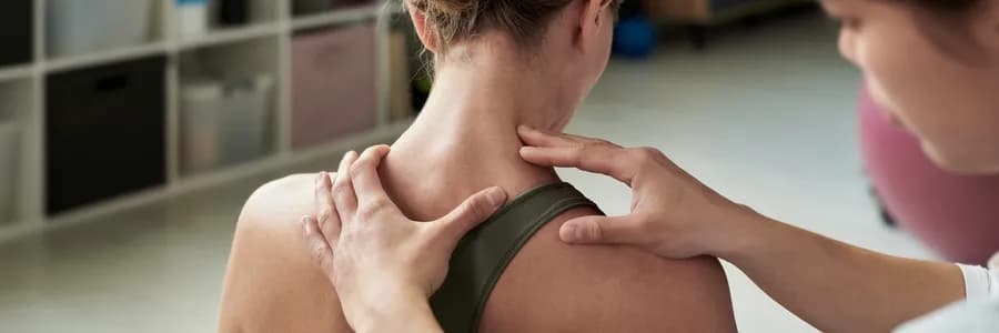 Physical therapist treating woman with neck pain