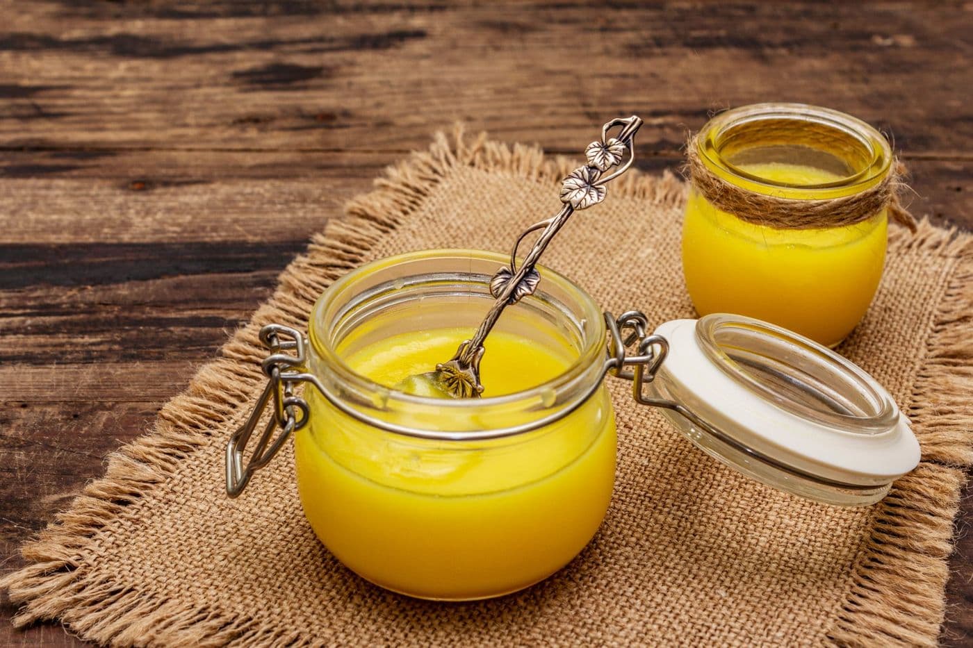 Homemade ghee butter in jars on a rustic table