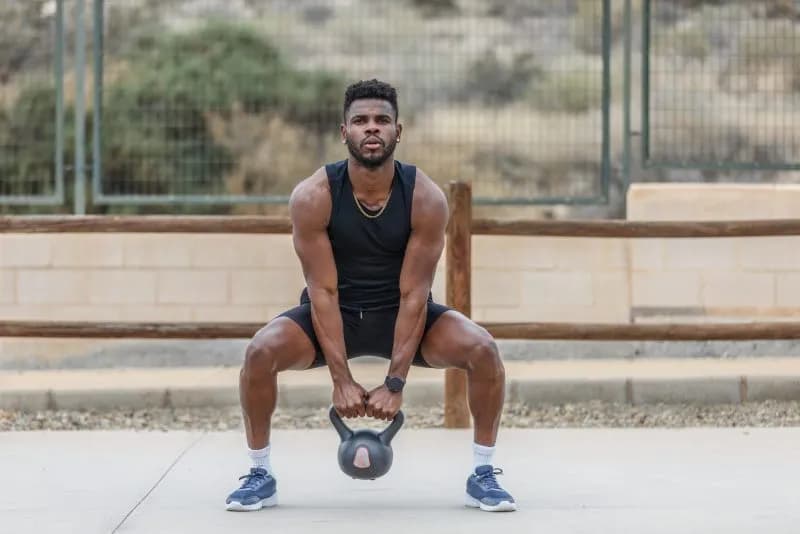 man-doing-kettlebell-workout-outside-on-sunny-day-2026-03-19-22-06-48-utc.jpg