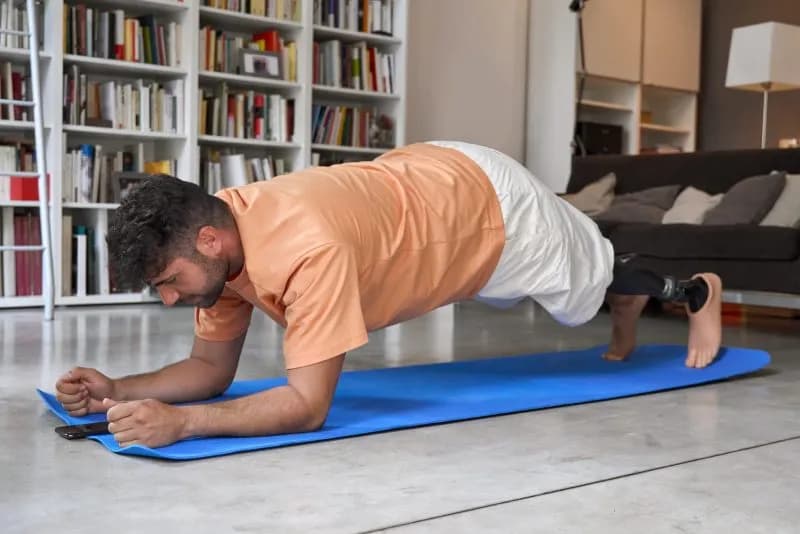 man doing plank exercise on a yoga mat