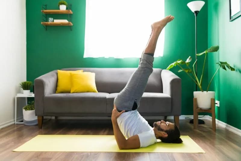 man practicing yoga indoors in a living room 2026 03 08 23 02 40 utc 4
