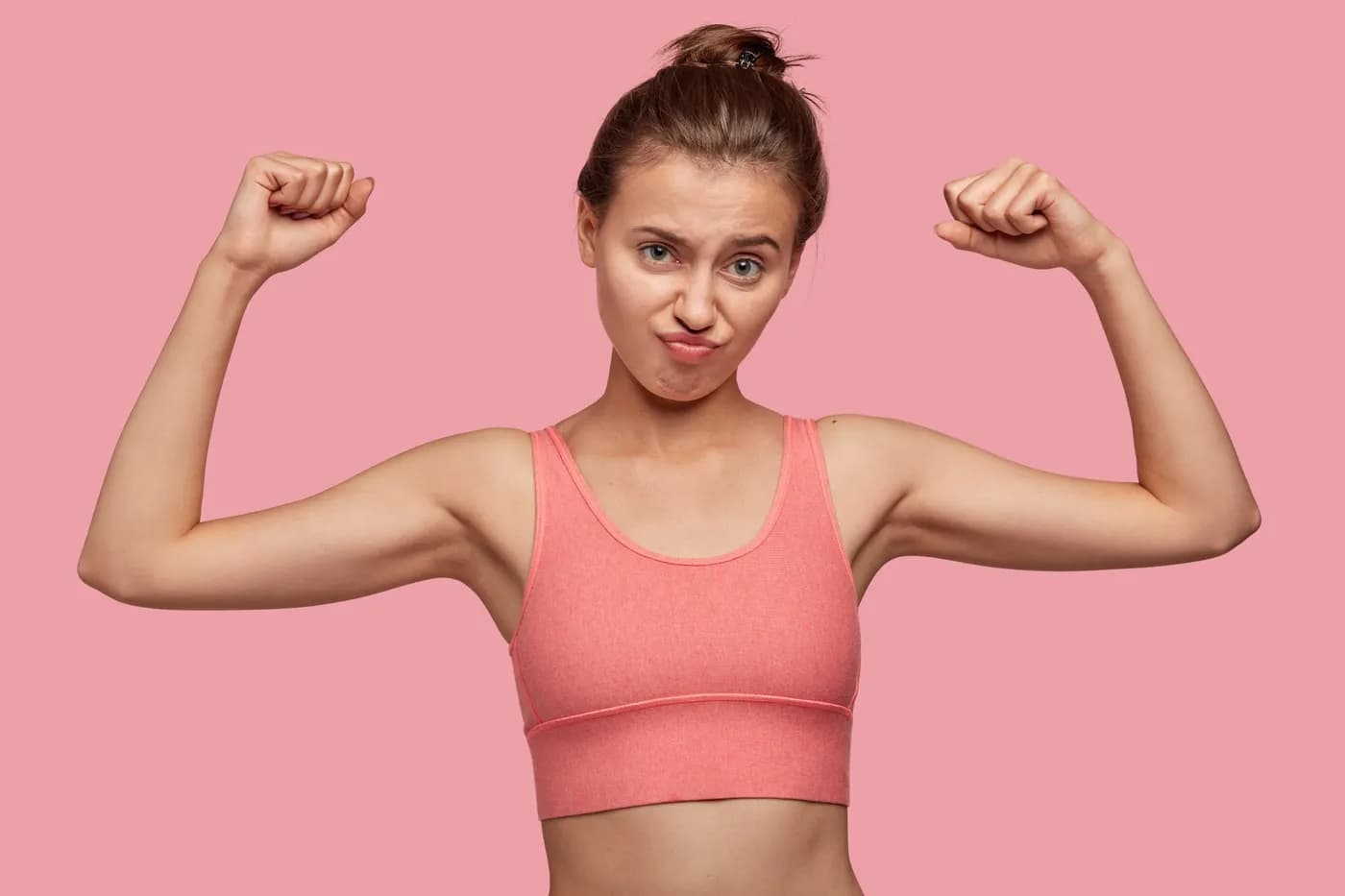 Woman flexing her muscles with a playful expression