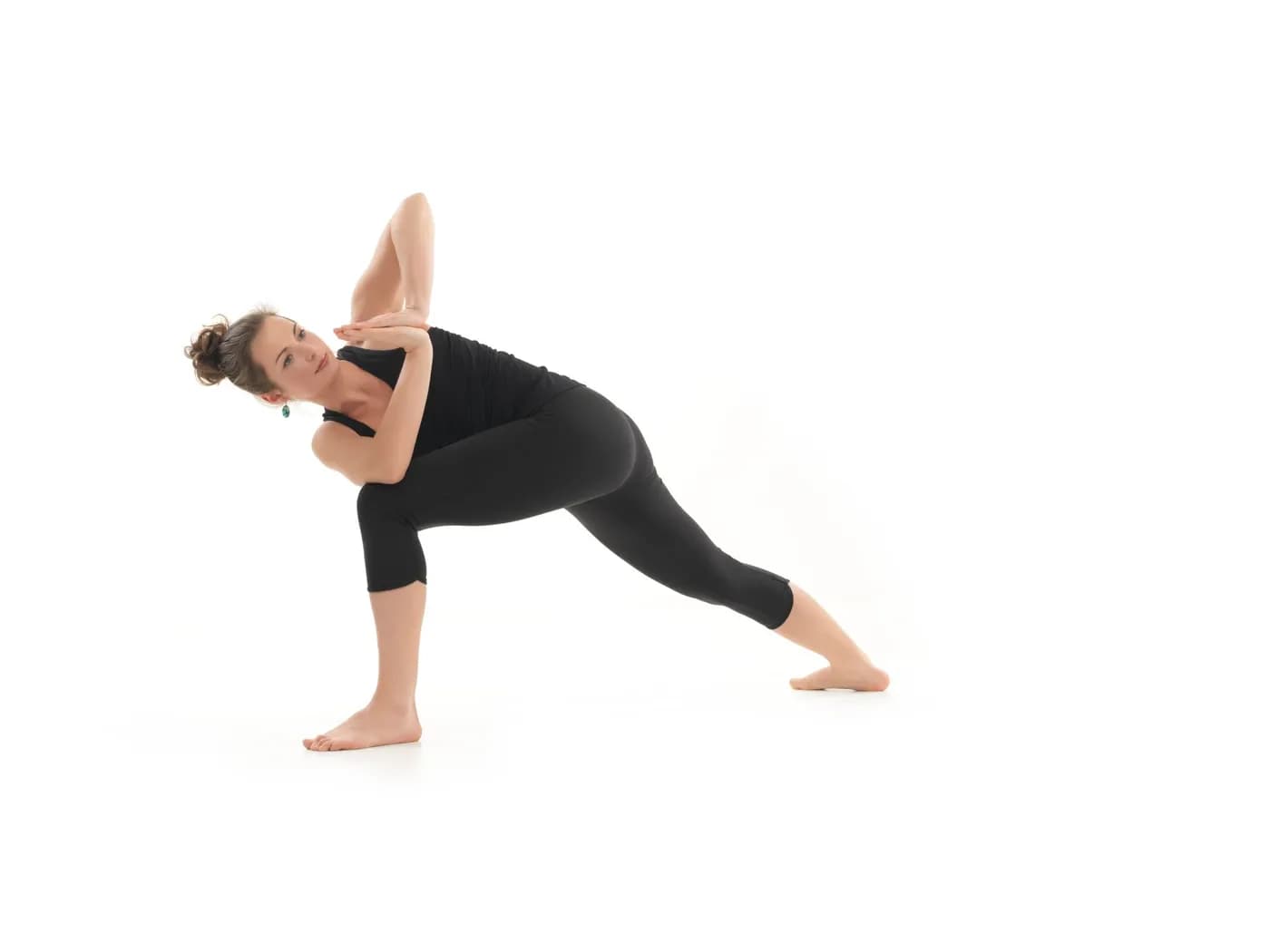 Woman demonstrating Parivrtta Parsvakonasana, the revolved side angle yoga pose