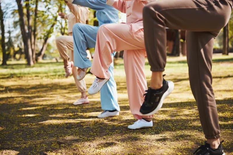 raised-legs-of-four-people-doing-exercise-in-park-2026-03-20-06-19-43-utc.jpg