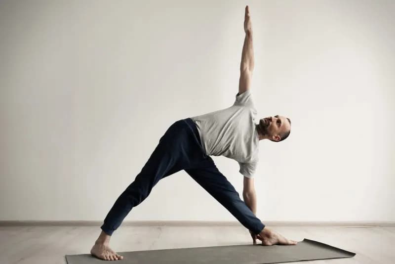 sporty man practicing yoga indoors 2026 02 05 22 00 20 utc