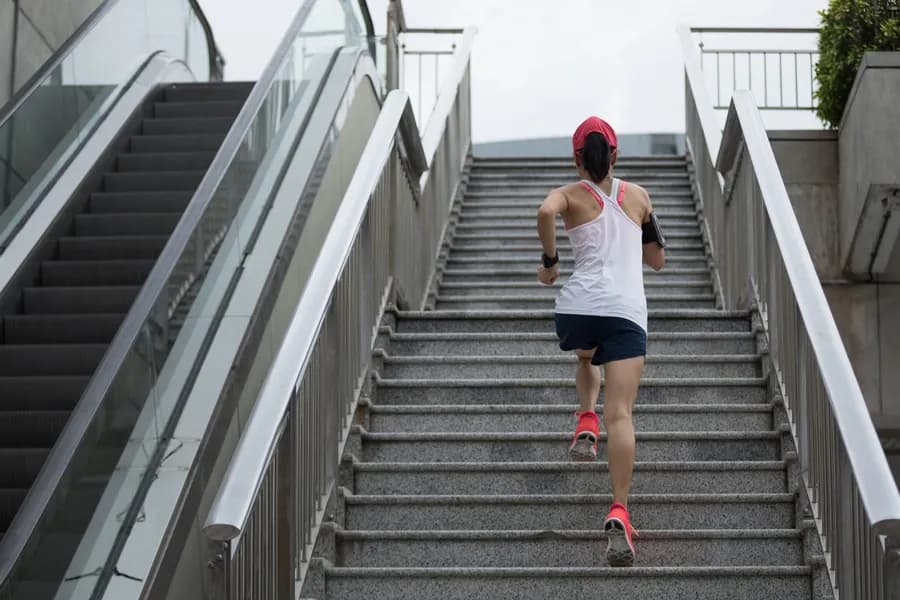 Woman climbing outdoor stairs during a stair climbing exercise workout