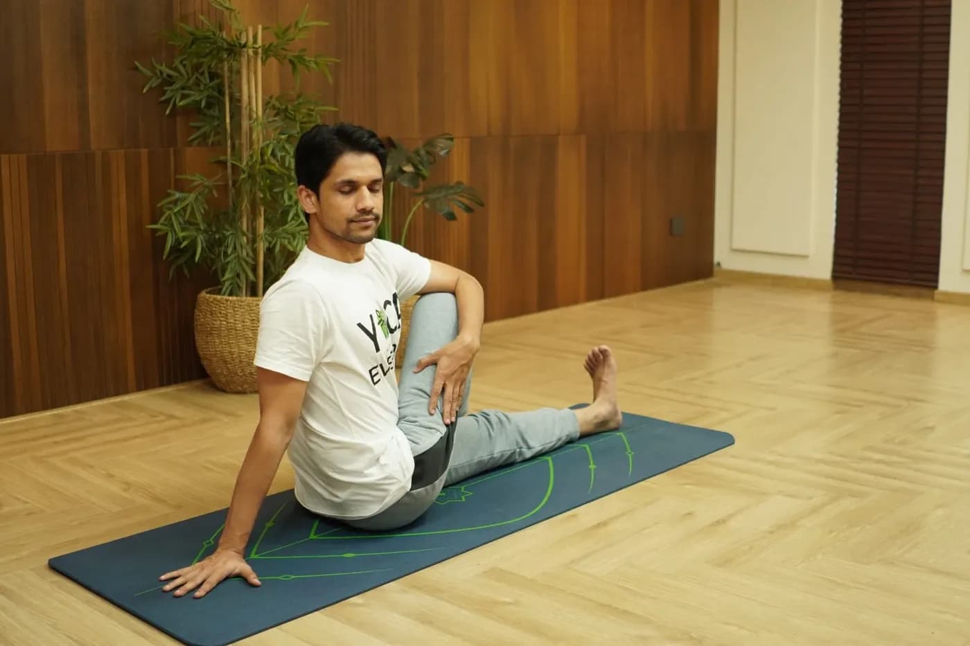 Person practicing Vakrasana seated spinal twist pose