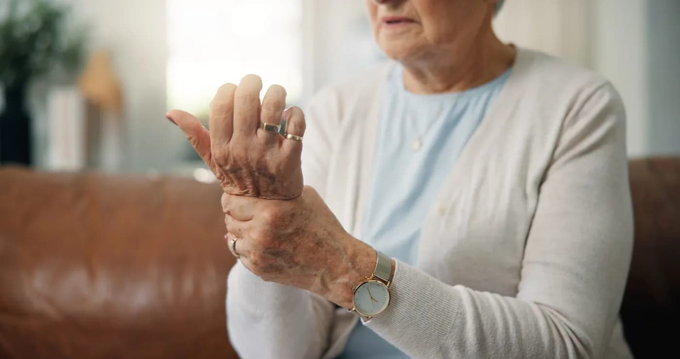 Elderly woman with hand and wrist pain from arthritis