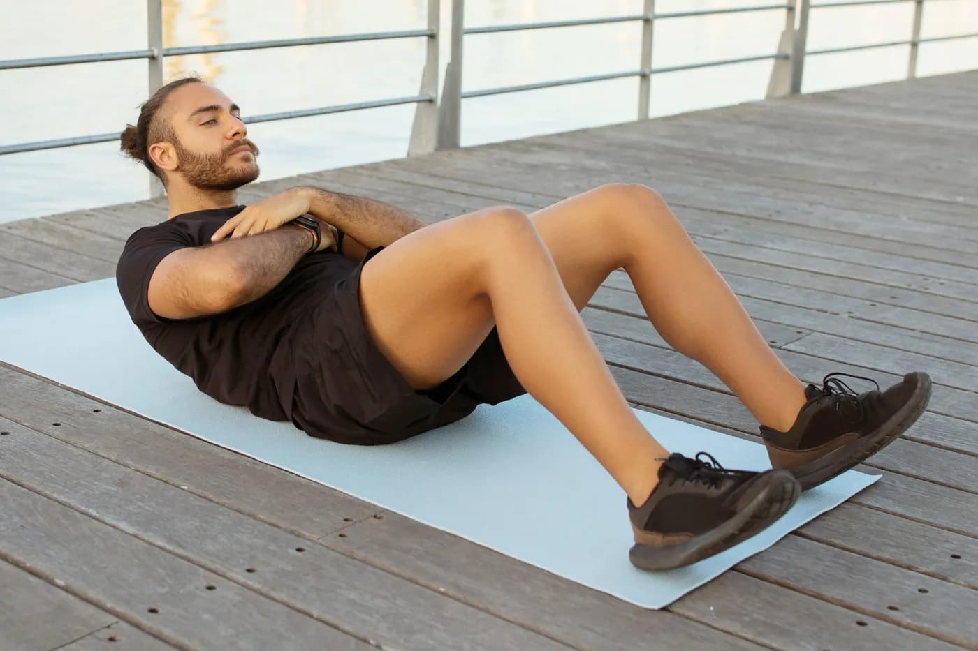 Man doing crunches exercise on a mat to build core strength