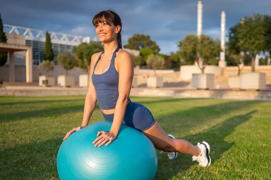 Woman exercising outdoors with an exercise ball