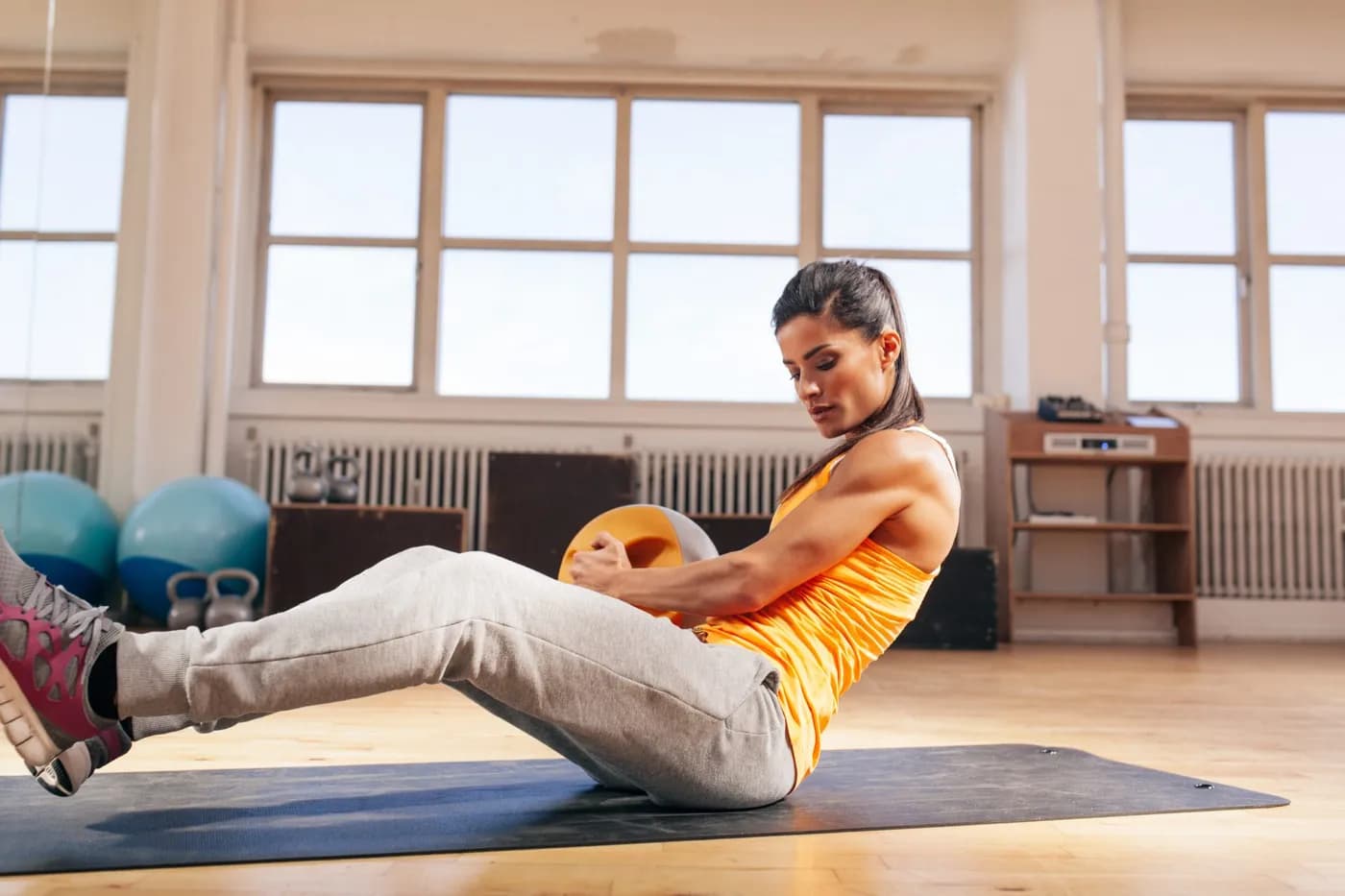 Young woman doing a core workout at the gym