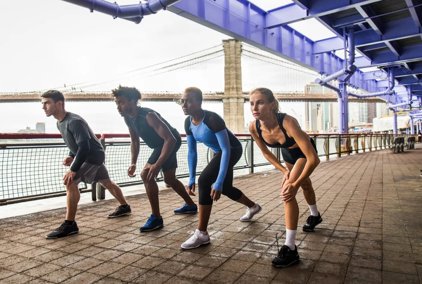 Runners sprinting outdoors during a strenuous training session