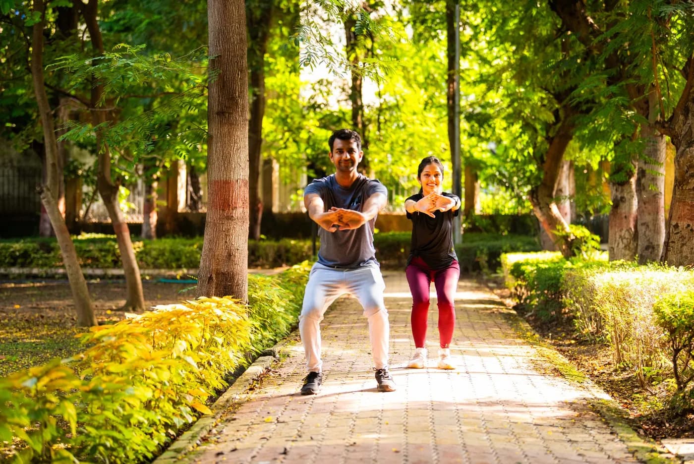 Energetic young couple doing aerobic exercise together in the park