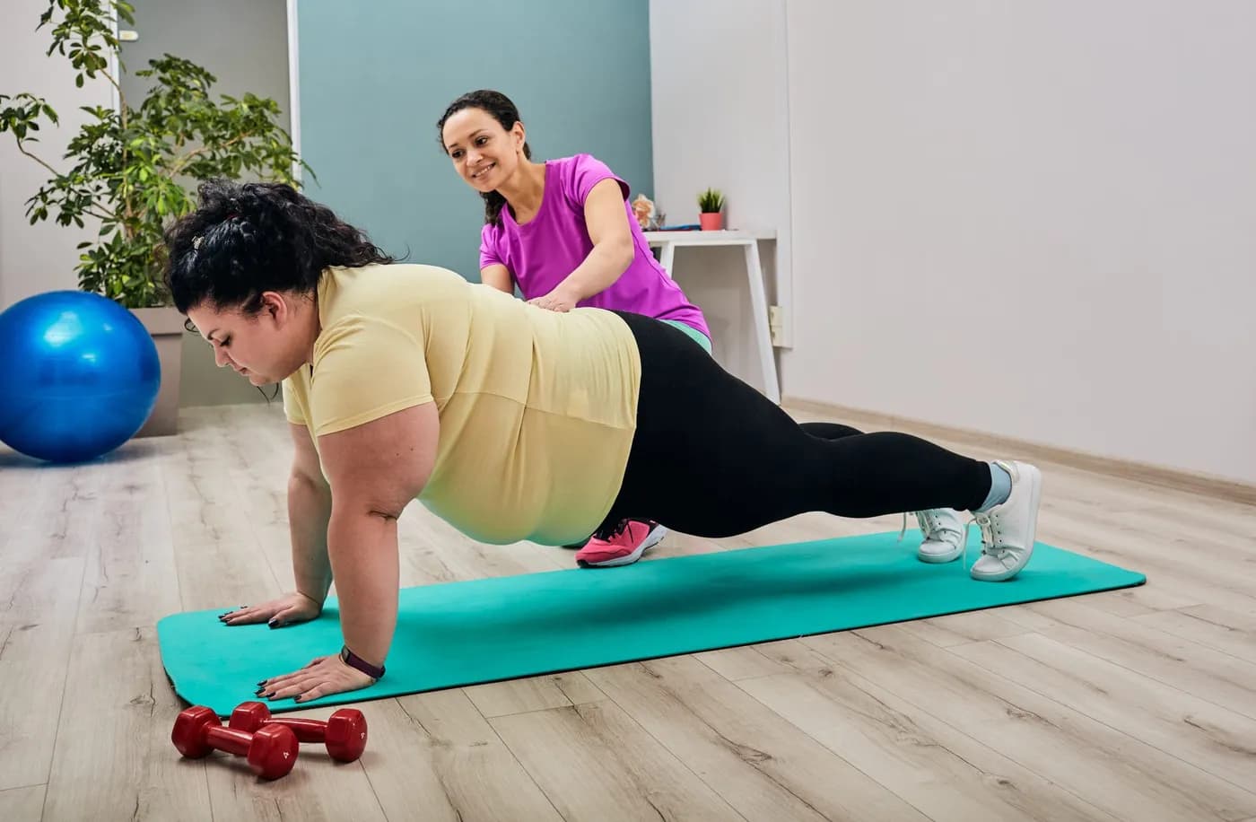 Woman training with an instructor at home doing exercises for weight loss