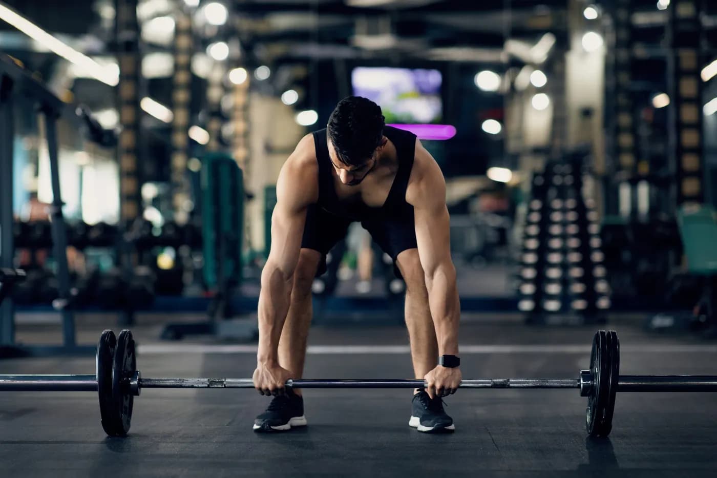 Man lifting weights in a gym setting