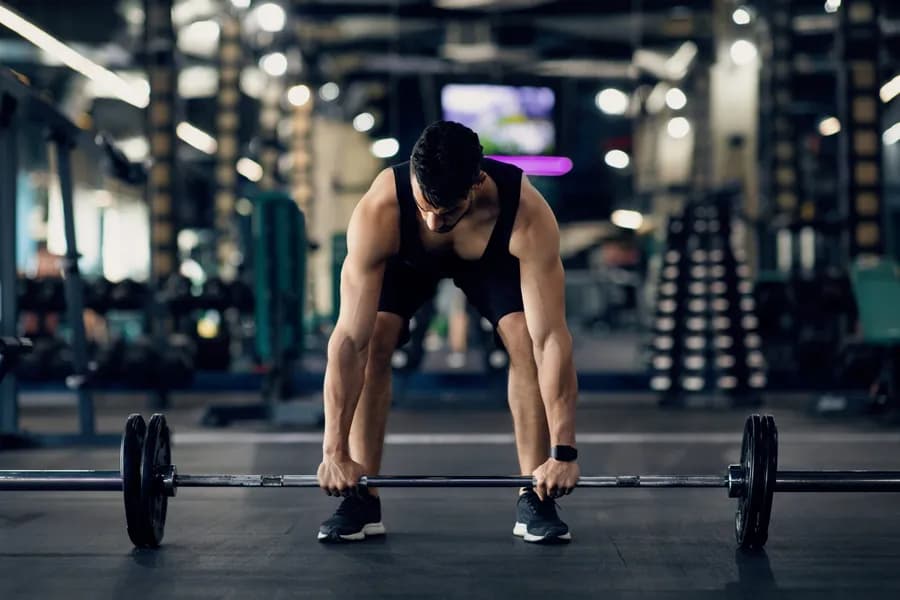 Man lifting weights in a gym setting