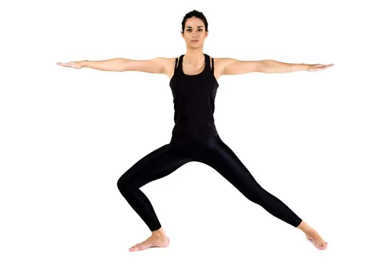 Woman in warrior pose during a home yoga practice