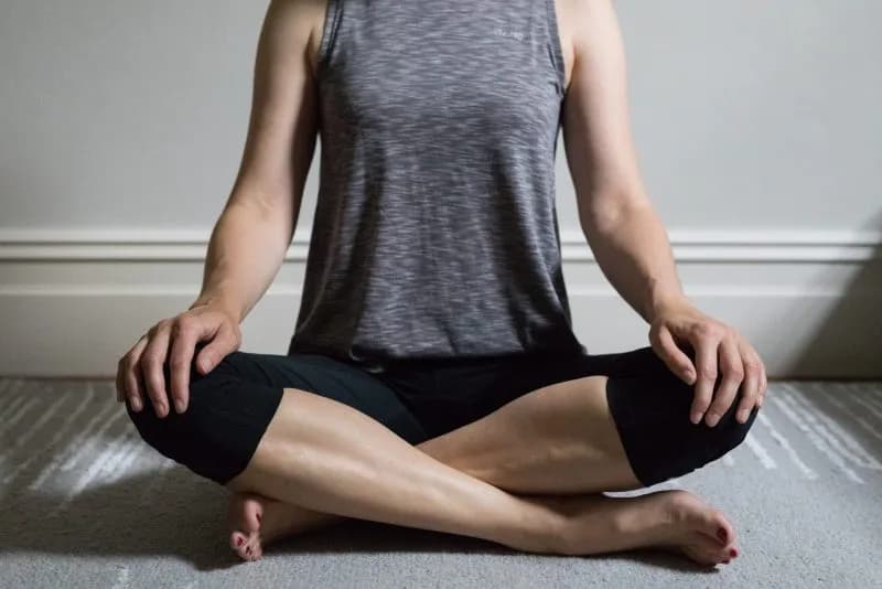 woman meditating at home on a gray carpet 2026 01 08 05 49 30 utc