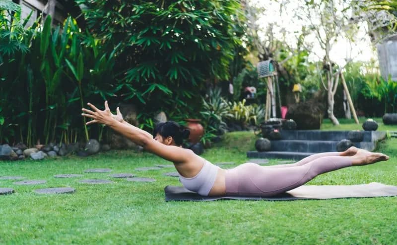 woman practicing yoga on lawn in serene garden 2026 03 24 22 43 45 utc